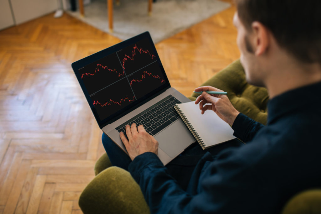 Man using a laptop for trading the stock market. 